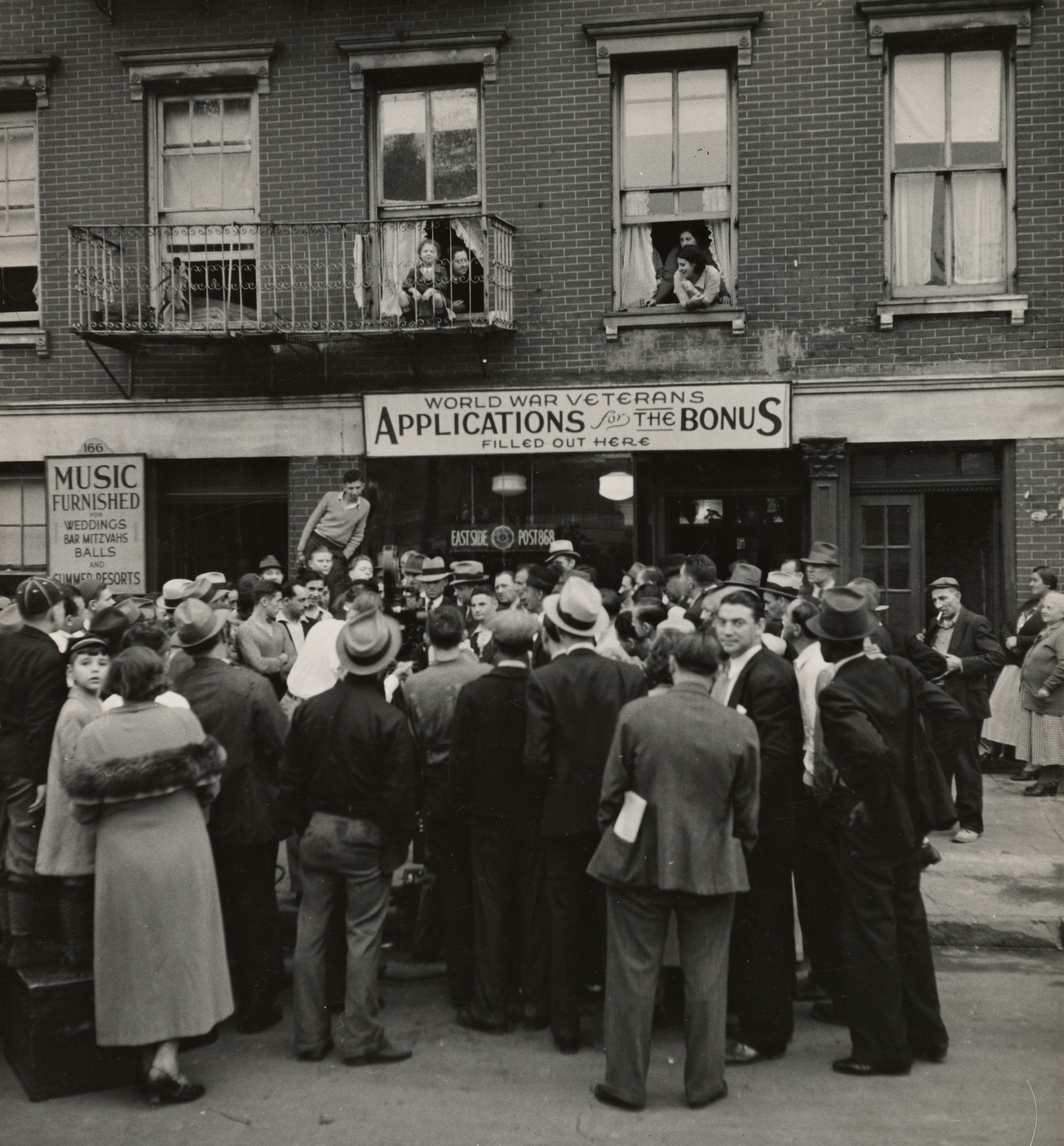 grayscale photo of people standing near the post office building